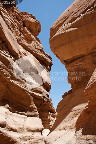 Image of Narrow slot between two rocks in desert canyon