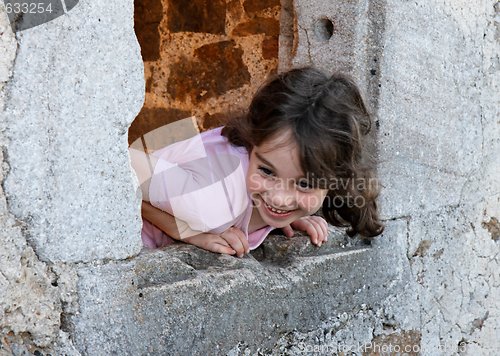 Image of Smiling girl leans out of the castle window