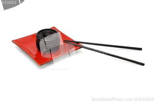 Image of Objective lens on square oriental plate with chopsticks isolated