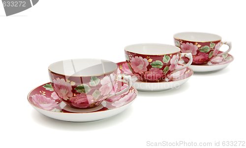 Image of Three beautiful  tea cups with saucers isolated