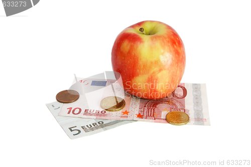 Image of Red apple on small euro bills with coins  isolated