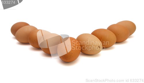 Image of edge of nine brown eggs isolated