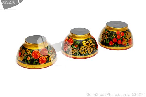 Image of Three painted Russian wooden cups upside down isolated