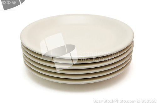 Image of Stack of plain beige dinner plates isolated