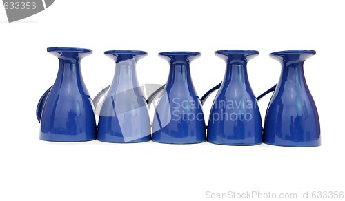Image of Row of five blue coffee cups upside down isolated