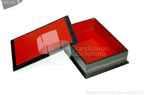 Image of Open wooden casket with red lining and lid isolated
