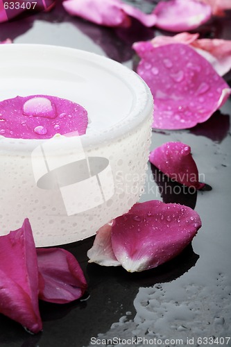 Image of Pink flower petal and water bowl decoration.