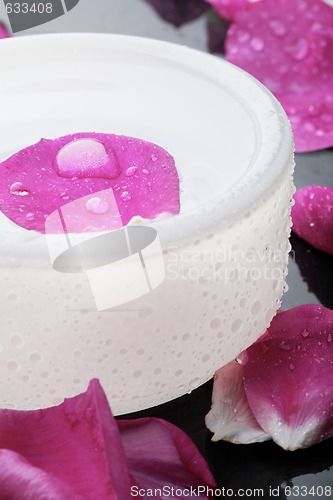 Image of Pink flower petal and water bowl decoration.