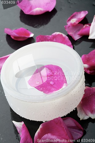 Image of Pink flower petal and water bowl decoration.