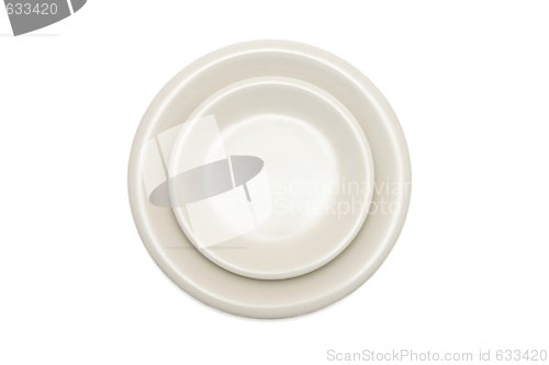 Image of Plain beige dinner plate and  saucer isolated top view