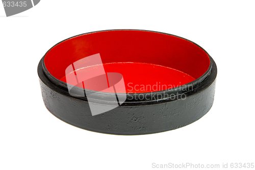 Image of Oval black wooden casket with red lining isolated