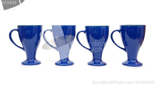 Image of Row of four blue high coffee cups isolated