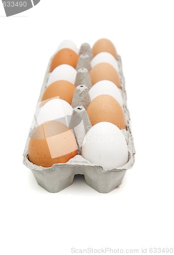 Image of White and brown eggs in a paper box in a chessboard order isolated