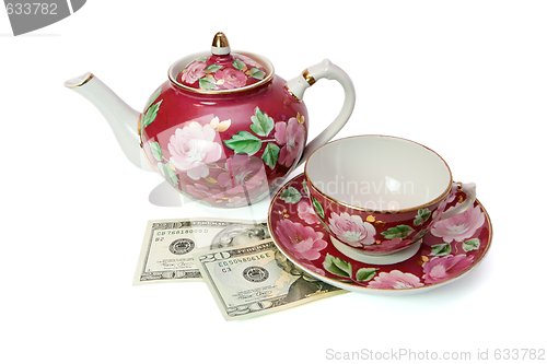 Image of Tea service stands on dollar banknotes isolated 