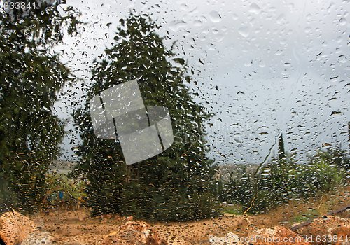 Image of Rainy landscape viewed  through a car window