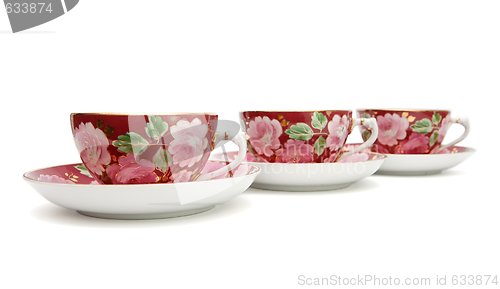 Image of Three tea cups with saucers  isolated