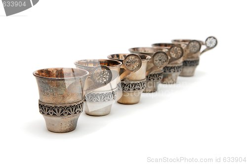 Image of Row of six vintage silver cups isolated