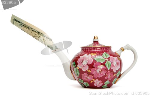 Image of Teapot with dollar bill sticking out of its spout isolated 