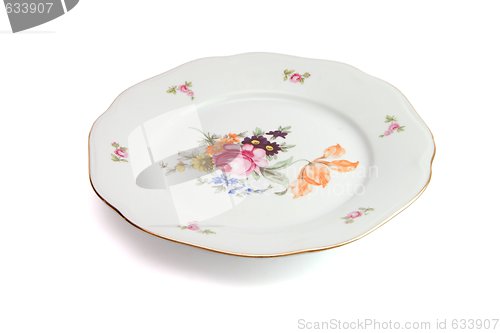 Image of White dinner plate with flowers and wavy rim isolated