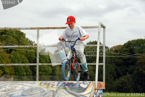 Image of Young boy rides bicycle