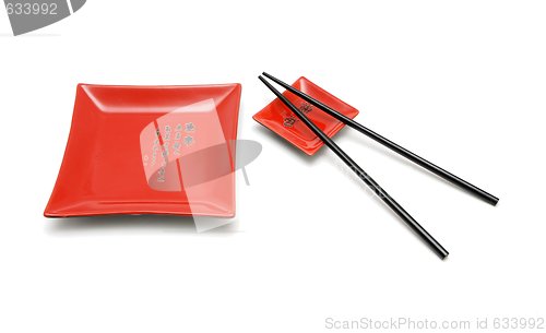 Image of Chopsticks, red square plate and saucer isolated