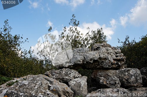 Image of Pyramid of lichen-covered gray rocks in cloudy day