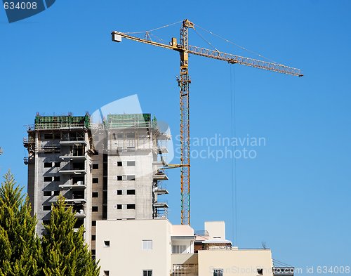 Image of Lifting crane and building under construction