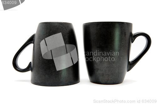 Image of Two black coffee cups up and down isolated