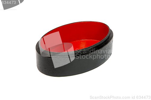 Image of Open empty oval black casket with red lining isolated