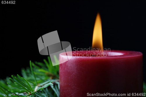 Image of Candle and birch branch in the dark.