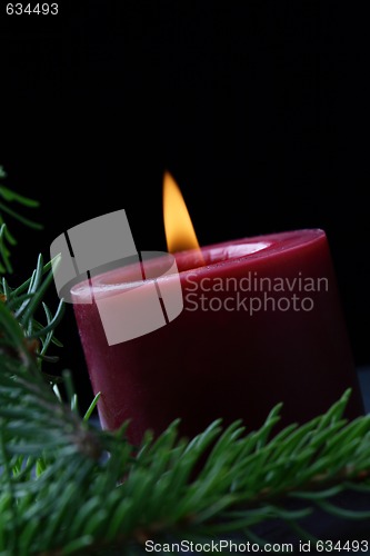 Image of Candle and birch branch in the dark.