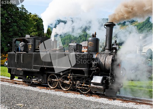 Image of Historical steam engine on tracks