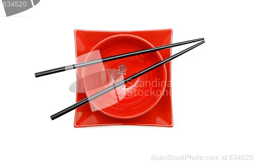 Image of Black chopsticks on red Japanese bowl  and square plate top view isolated