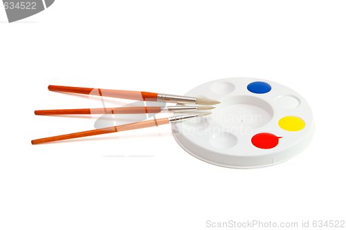 Image of Round kids palette with three paintbrushes isolated