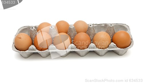 Image of Nine brown eggs in a paper box isolated