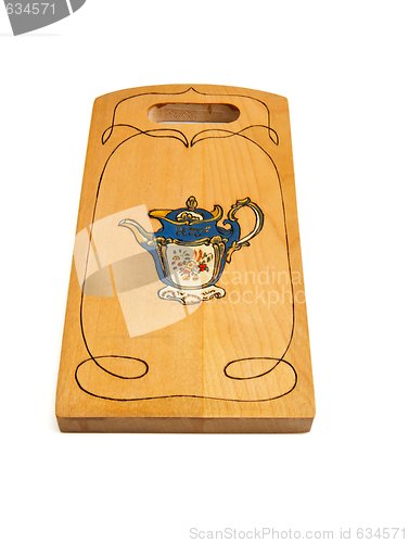 Image of Wooden cutting board painted with teapot isolated