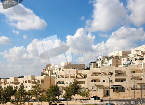 Image of New three-storeyed apartment buildings under blue cloudy sky