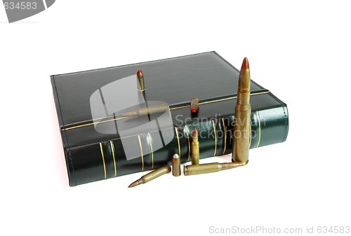 Image of Dark book and cartridges of various calibers isolated