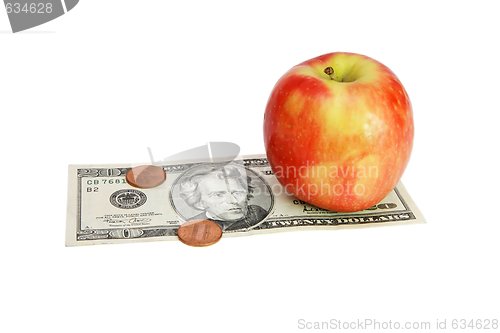 Image of Apple on twenty dollar bill with coins isolated