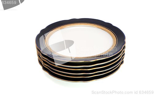 Image of Stack of dark-blue dinner plates with a golden rim isolated