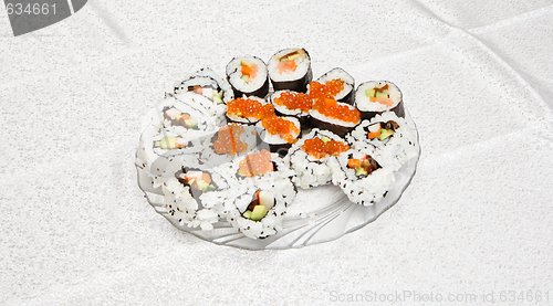 Image of Homemade sushi of several types with red caviar on glass plate 