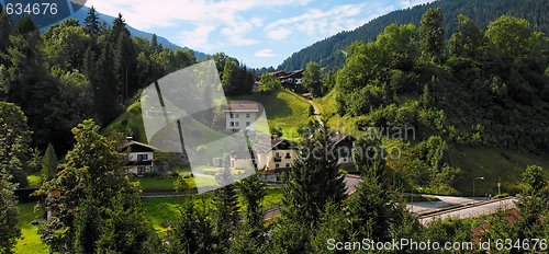 Image of Alpine village under the mountains at sunrise