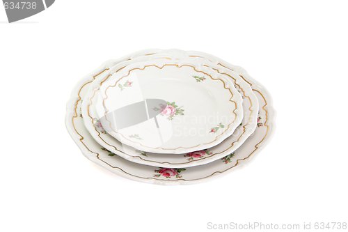 Image of Stack of three white dinner plates and saucers  isolated