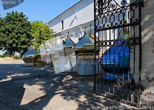 Image of Row of onion church domes on the ground 