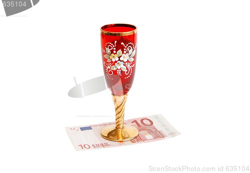 Image of Beautiful red wine glass on ten euro bill isolated 