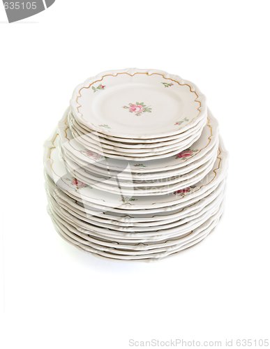 Image of High stack of white dinner plates and saucers isolated