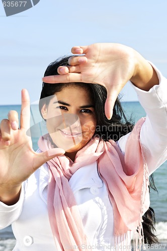 Image of Beautiful young woman framing her face