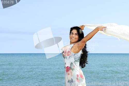 Image of Beautiful young woman at beach