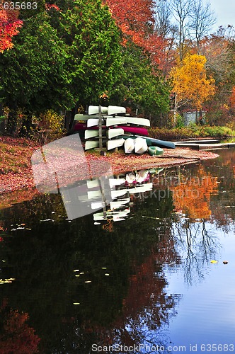 Image of Fall forest reflections with canoes