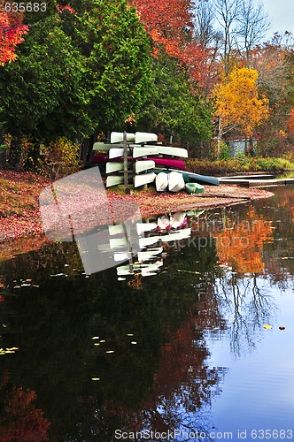 Image of Fall forest reflections with canoes